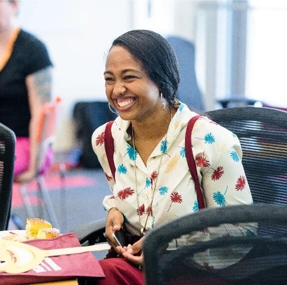 An ASU student smiles at an event on campus.